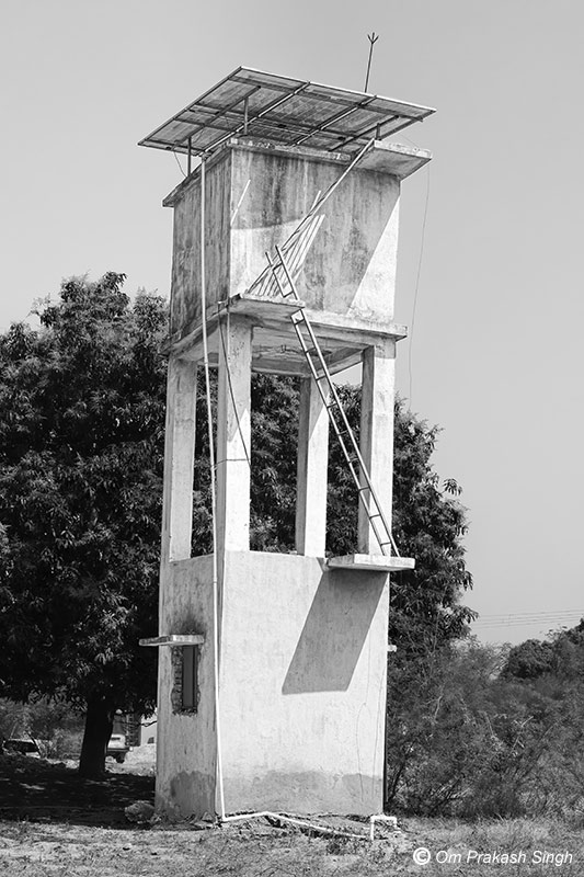 A higher capacity single-village scheme comprising an overhead tank made of RCC, operated by a solar-powered motor under Jal Jeevan Mission in Jharkhand, India